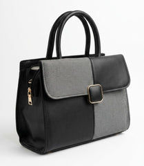 Two-tone structured satchel bag shown at an angle with side zip detail