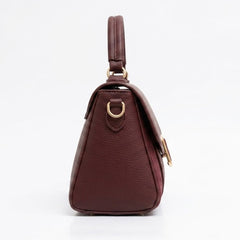 Side profile of burgundy flap bag showing depth