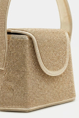 Close-up of gold rhinestone bag showing crystal texture and flap
