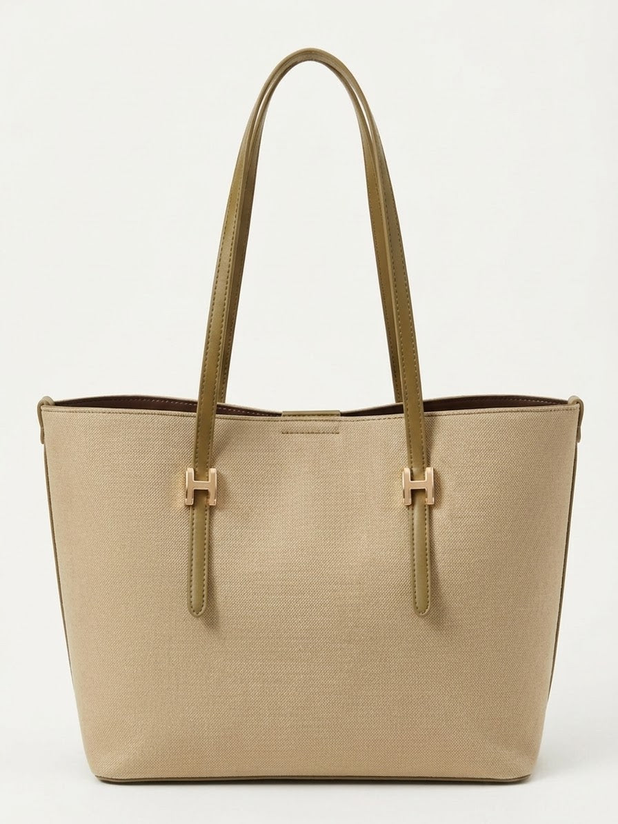 Beige textured shopper tote bag with gold buckle straps, front view