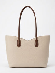 Cream pebbled leather tote with brown contrast handles, front view
