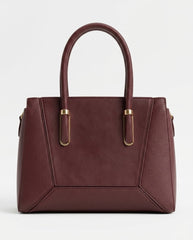 Burgundy structured satchel bag with gold handle bars, front view