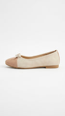 Cream suede ballet flat with tan cap toe, side view