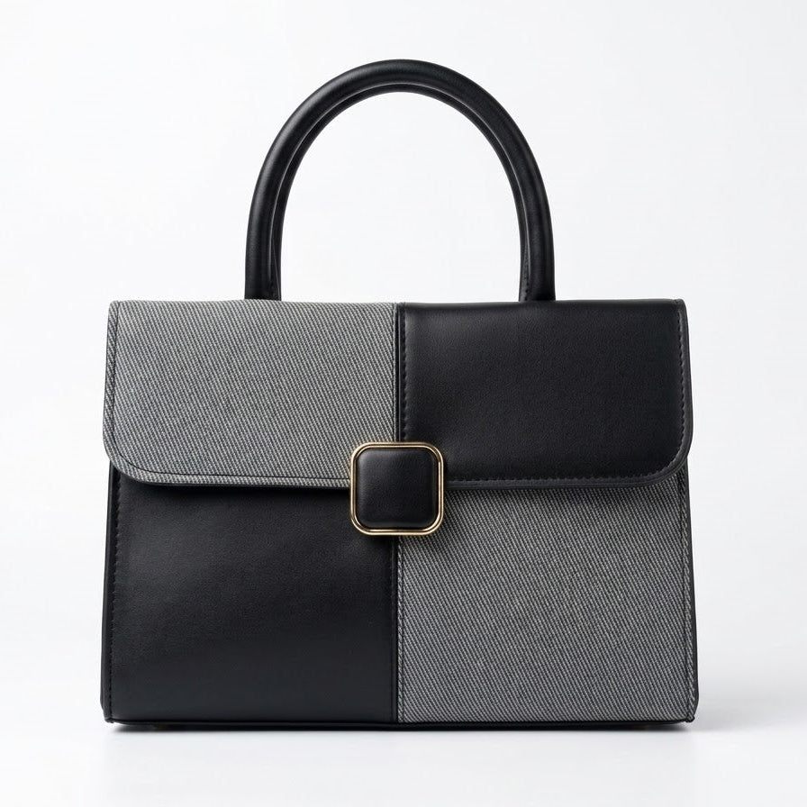Two-tone black and grey structured satchel bag, front view with gold buckle