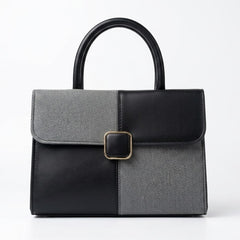 Two-tone black and grey structured satchel bag, front view with gold buckle
