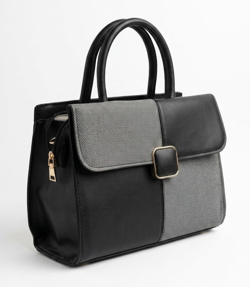 Two-tone structured satchel bag shown at an angle with side zip detail