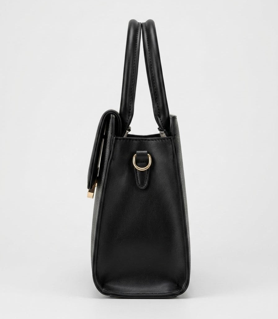 Side profile of black structured satchel bag showing top handles