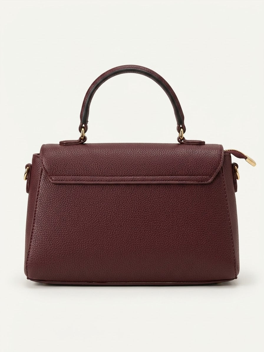 Back view of burgundy top handle flap bag with detachable strap