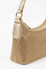 Angled view of gold rhinestone baguette bag showing crystal texture
