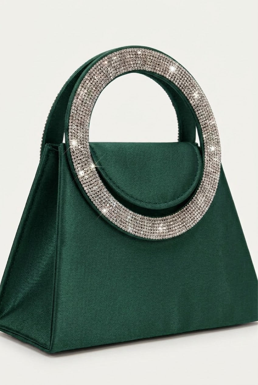 Angled view of green trapeze bag showing crystal handle