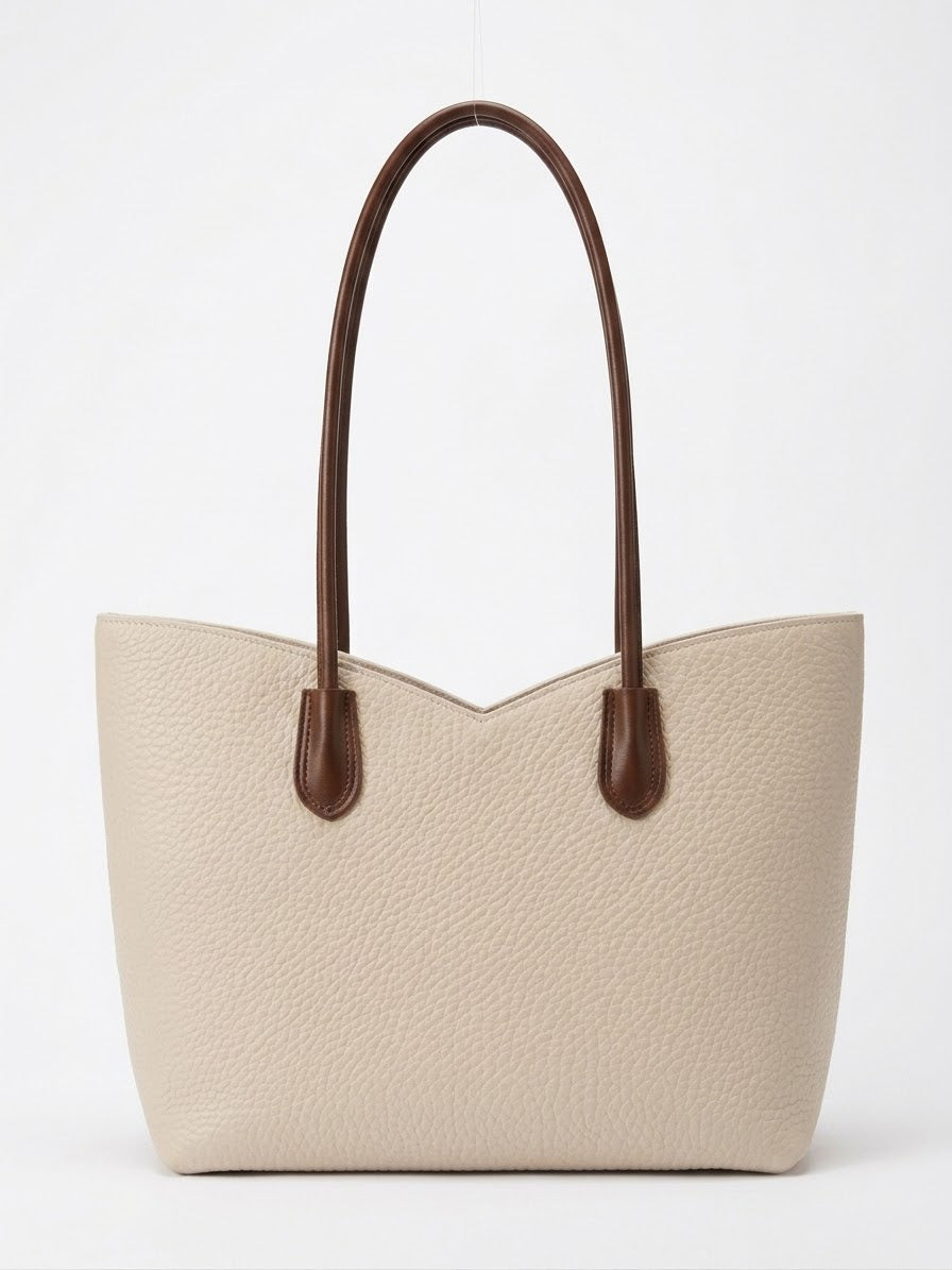 Cream pebbled leather tote with brown contrast handles, front view