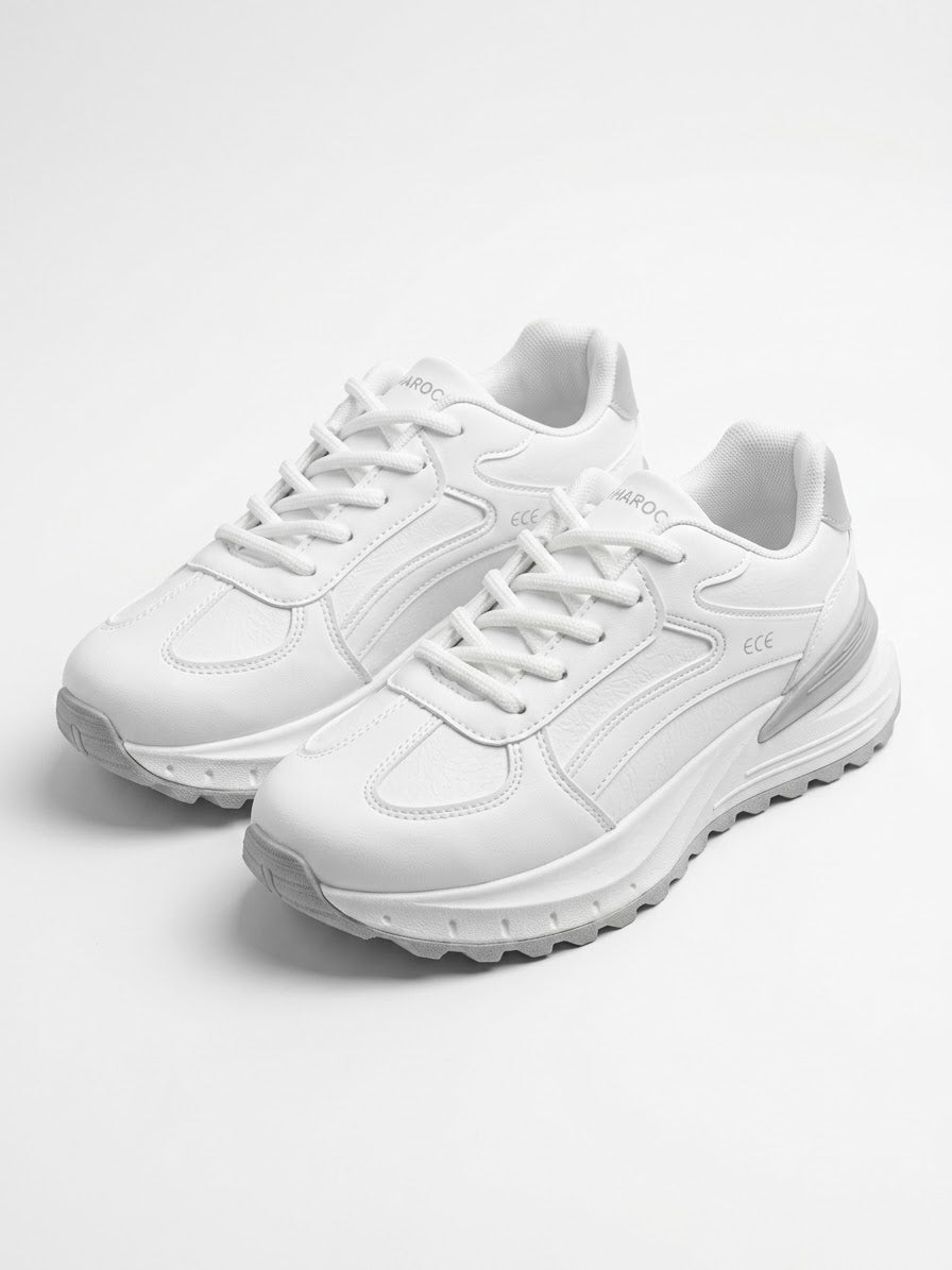 Pair of white runner sneakers viewed from above