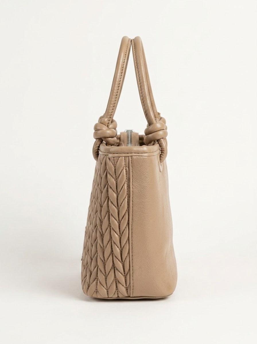 Side profile of taupe chevron quilted tote
