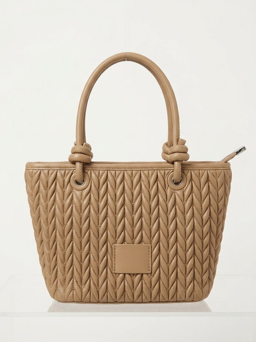 Taupe quilted tote shown straight on with side zip