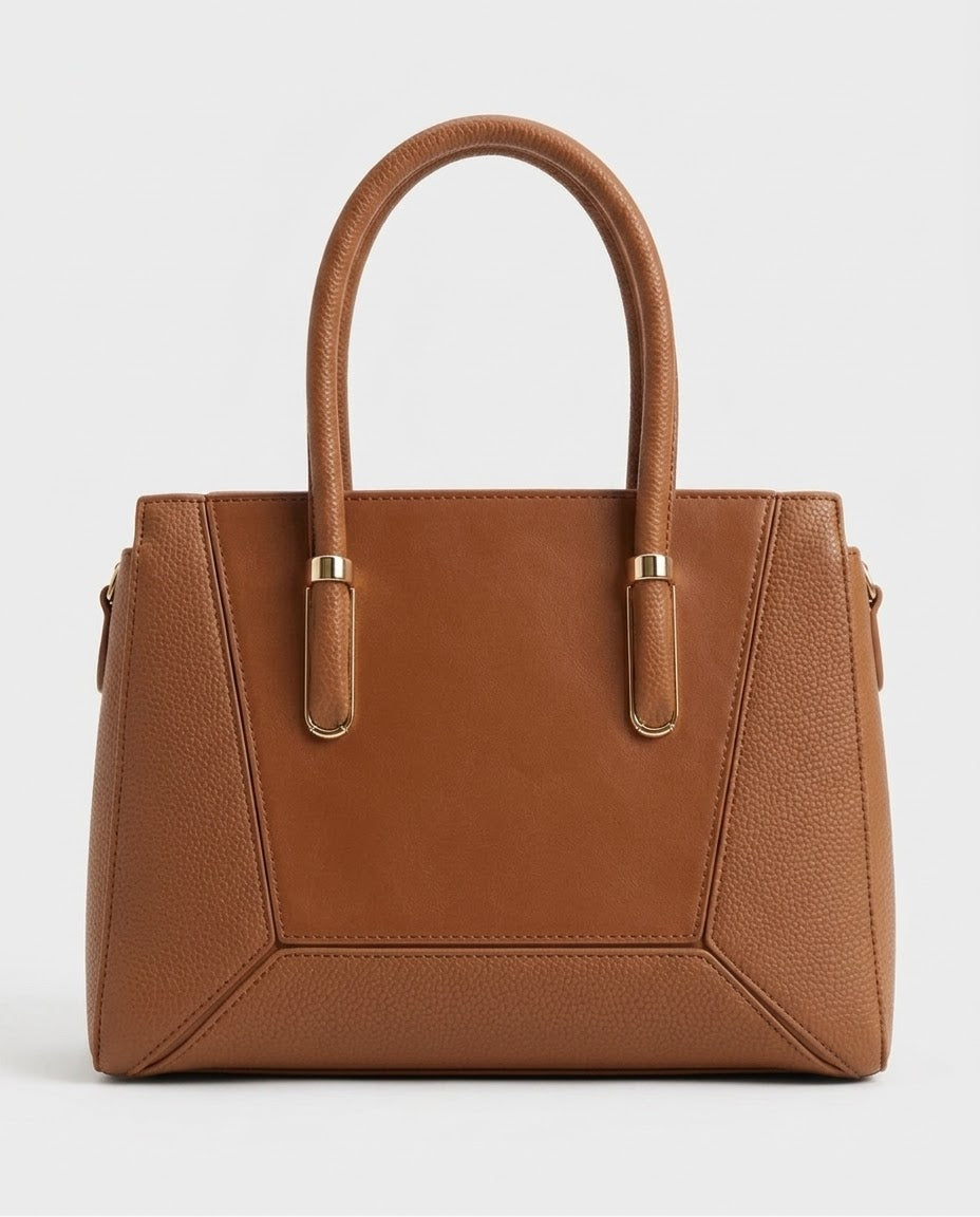 Tan structured satchel bag with gold handle bars, front view