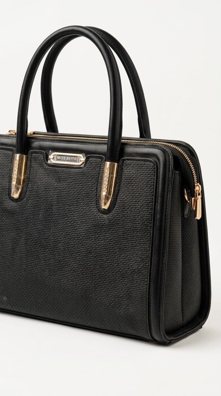Angled view of black woven frame handbag showing texture