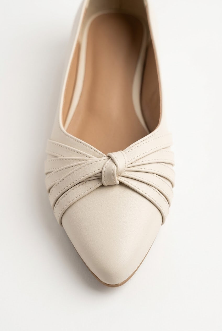 Close-up of cream flat showing gathered knot detail