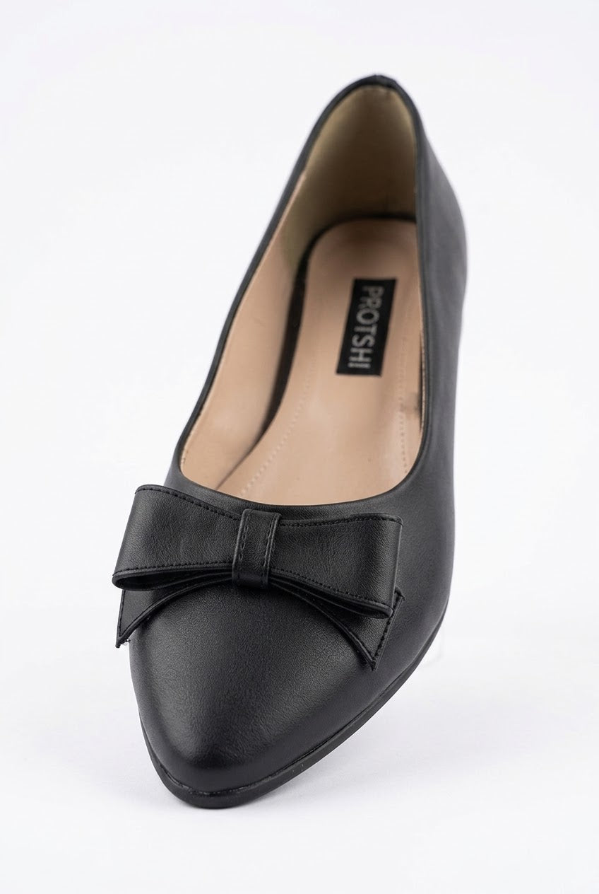 Close-up of black bow pointed ballet flat
