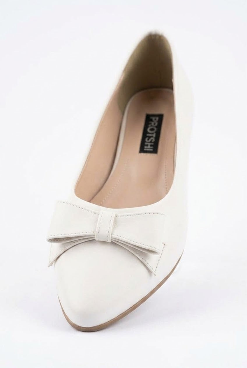 Close-up of white bow pointed ballet flat