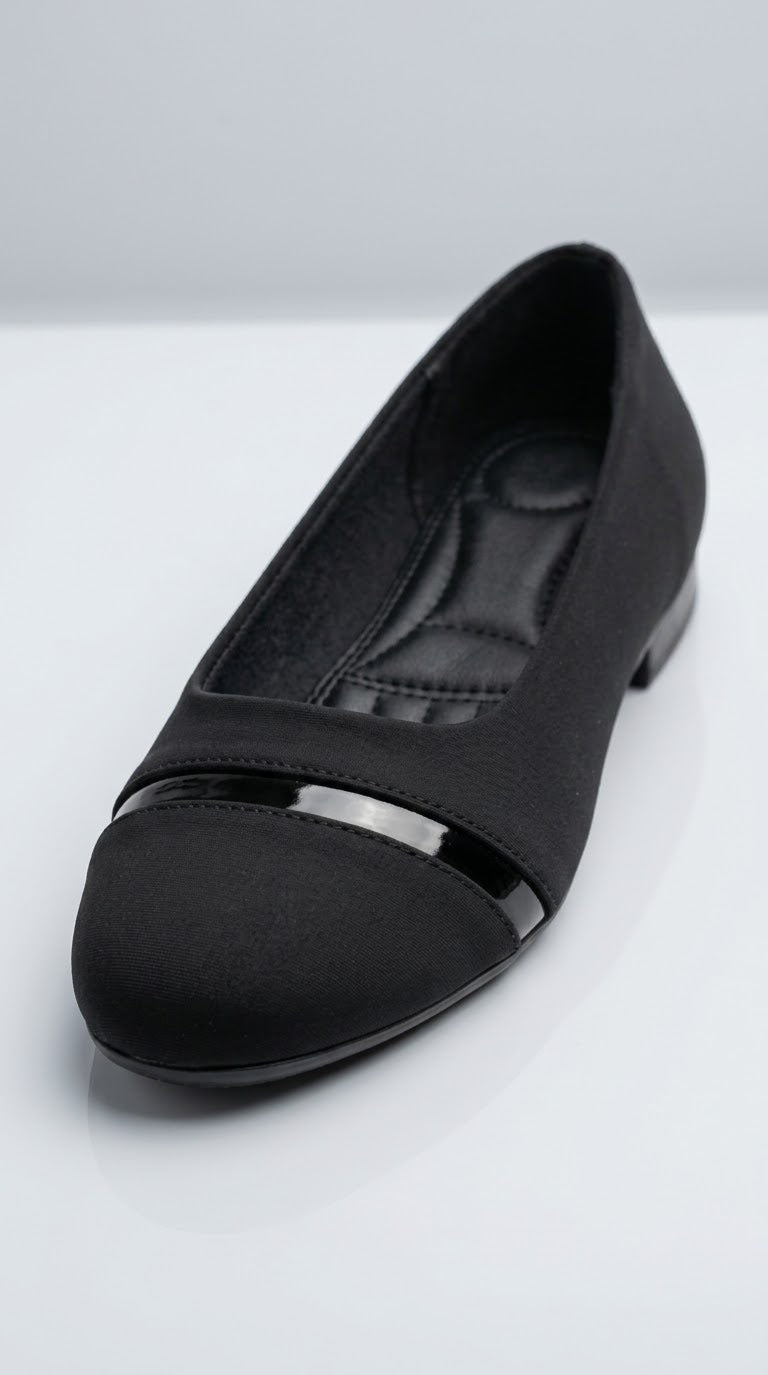 Close-up of the patent toe cap and bar on a black ballet flat