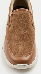 Close-up of the toe and sole on a tan suede slip-on sneaker