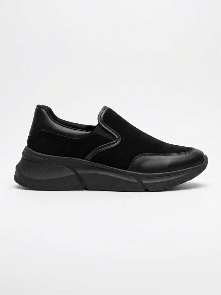Black suede and leather slip-on sneaker with a black sole, side view