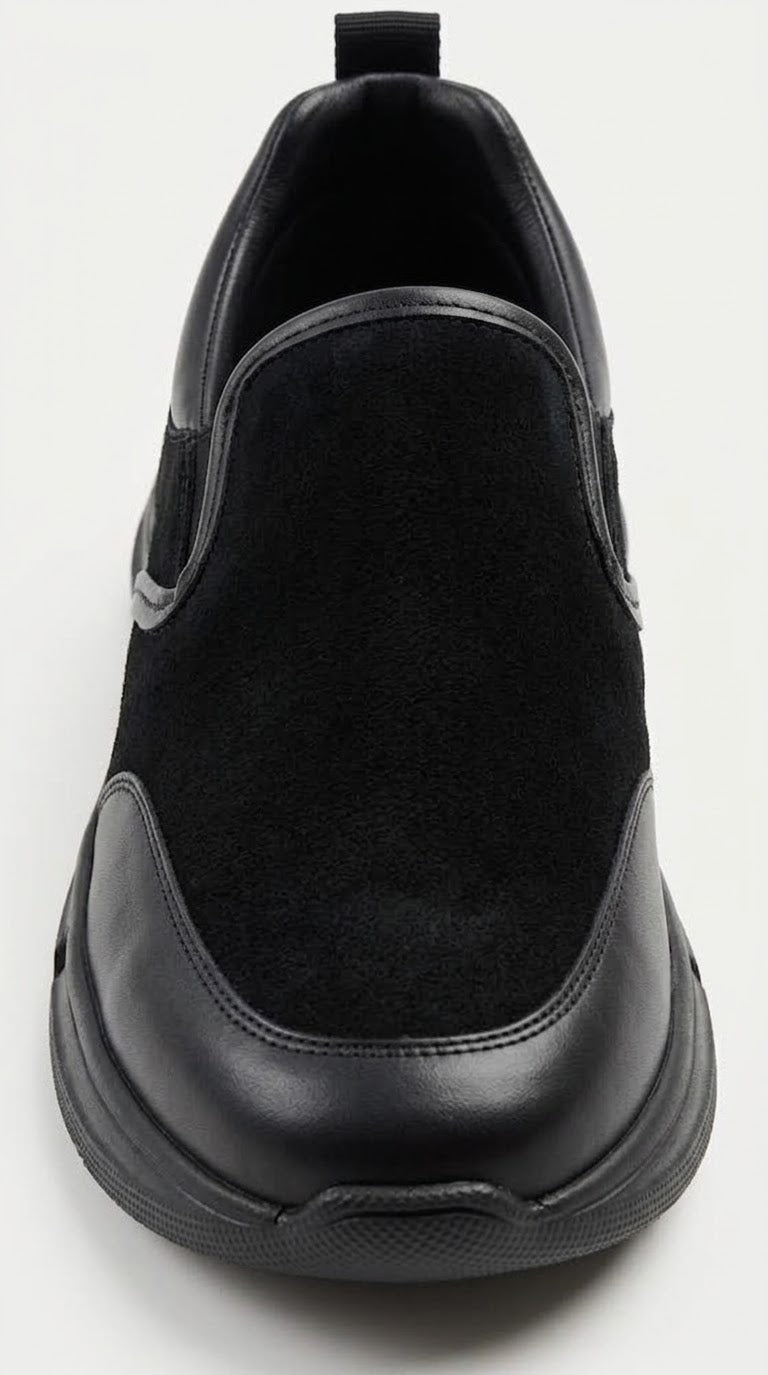 Close-up of the toe and elastic gore on a black slip-on sneaker