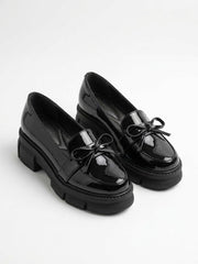 Black patent chunky lug sole bow loafers, pair
