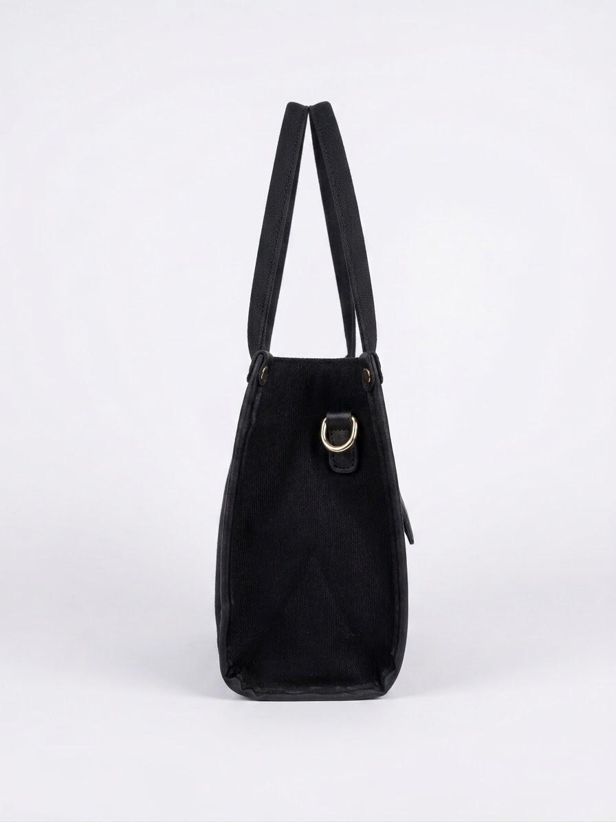 Side profile of black canvas tote bag